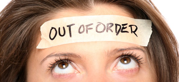 Woman with Out of Order Sign on Head